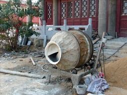 manual concrete mixer in front of the building