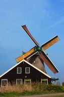 Windmill among the traditional landscape of Holland