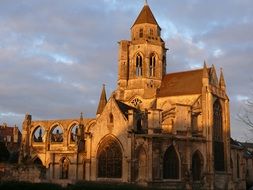 ruined medieval Church of St Etienne at evening sky, France, Caen