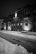 stone house among the winter landscape in black and white image