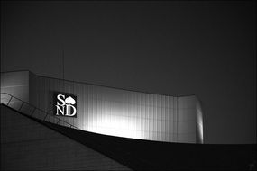 illuminated advertisement on a building at night