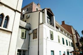 house with white walls at blue sky background on a street in croatia