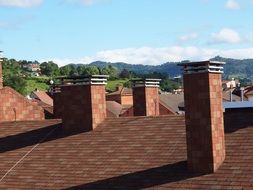 red tiled roof with chimneys construction