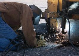 welder in helmet at work