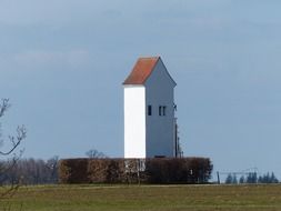 white tower house in the field