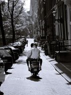 couple in love on a moped in the street