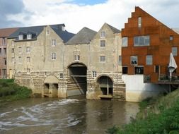 landscape view of the creek among historic city architecture in Aarschot