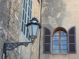 street lamp on the facade of an old stone building, mallorca