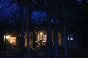 cottage among the trees on the Finnish lake at night