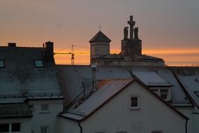 orange sunset over silhouettes of rooftops