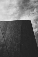 modern architecture under a cloudy sky, black and white