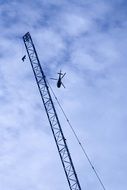 helicopter over a construction crane in london