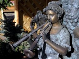 statue girl with music instrument