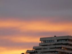 top of grey building at colorful sunset sky