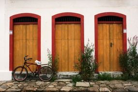 vintage bike on cobblestone pavement at colonial building, Brazilia, paraty