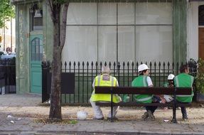 builders are sitting on a bench