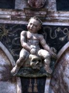 statue of a child on the facade of the church