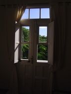 wooden window at backlight of the sun