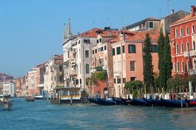 row of gondolas at waterfront in old city, italy, venice