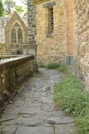 old stone walkway along wall