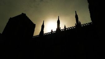 silhouette of wall with towers at sky