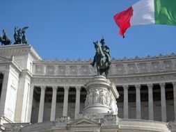 historic monument and ancient building with italian flag in rome