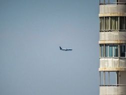 building windows and plane in the sky