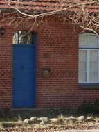 blue front door of a brick building