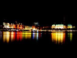 multi-colored night illumination of Hamburg a view from the water