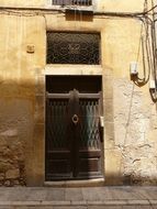wooden decorative door of the old building, spain