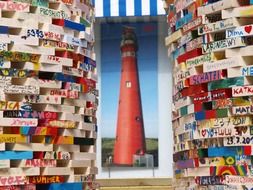 lighthouse behind the brick wall