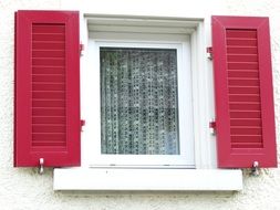 Red shutters on the window