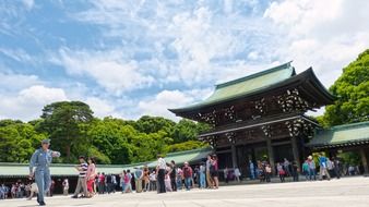 a crowd of people near the temple in Tokyo