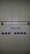 take a smile, paper motivator on wall
