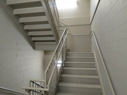 white staircase in the middle of the building