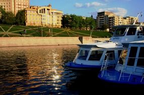 cruisers on a river in the city