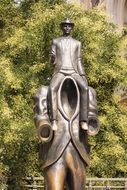 kafka monument iron statue near the colorful plants