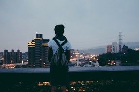 back view of girl looks at the city