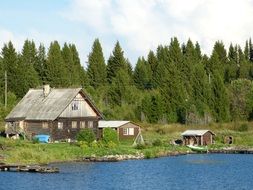 house by the river near the forest in Russia