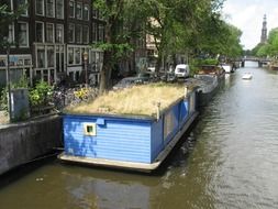 blue barge on the canal in amsterdam