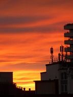 antennas on the roof on a scarlet sunset