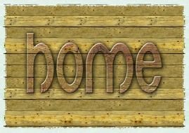 the word &quot;home&quot; on the background of wood texture
