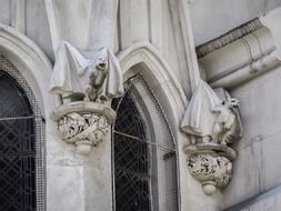 statues of gargoyles on a facade of gothic cathedral