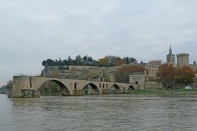 The Saint-Benese Bridge is located on the Rhone River at cloudy sky background