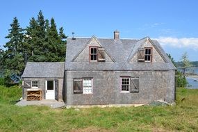 stone house on a green meadow