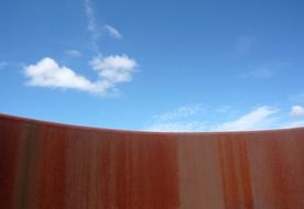 blue sky and red wall