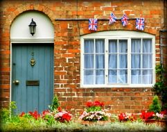 British flags on the facade of an English cottage