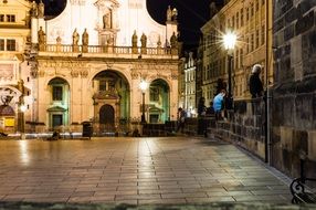 square with lights at night in prague