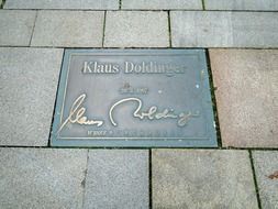 klaus doldinger sign on the pavement road