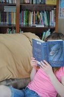 young girl with enthusiasm reads the book